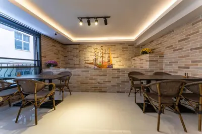 a dining room with brick walls and wooden tables and chairs at Rubby Kadıköy in Istanbul