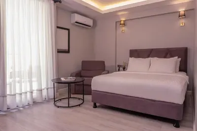 a bedroom with a bed and a chair and a table at Rubby Kadıköy in Istanbul