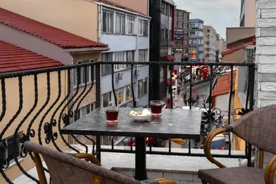 a table on a balcony with two drinks and a bowl of food at Rubby Kadıköy in Istanbul