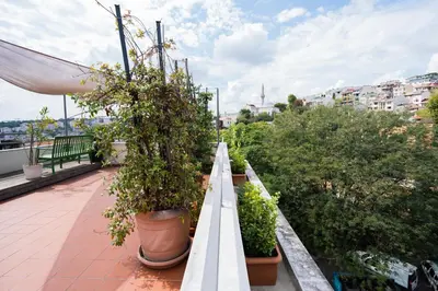 a balcony with potted plants on top of a building at İstanbul Smart Apart by SUMMITVISTA in Istanbul