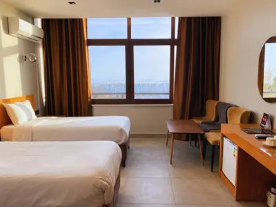 a hotel room with two beds and a window at Elite Marmara Bosphorus Çamlıca in Istanbul
