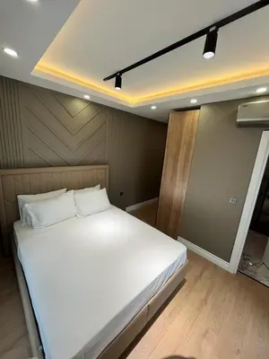 a large white bed in a room with wooden floors at Serim Residence in Kocaeli