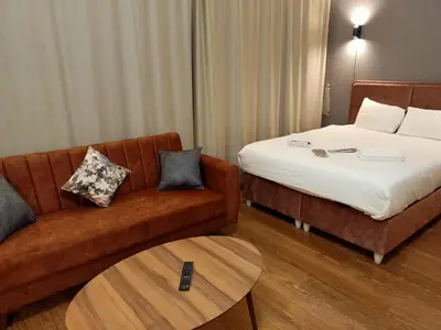a hotel room with a couch and a bed at Doğan Palace Hotel in Istanbul