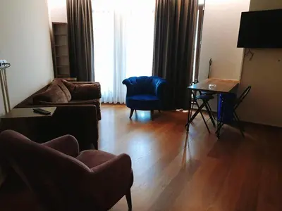 a living room with a couch and a table at Doğan Palace Hotel in Istanbul