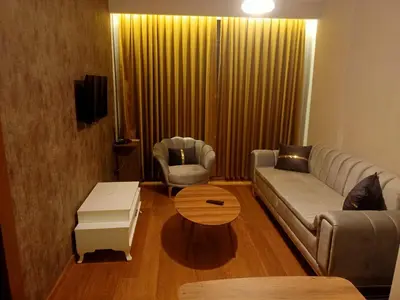 a living room with a couch and a coffee table at Doğan Palace Hotel in Istanbul