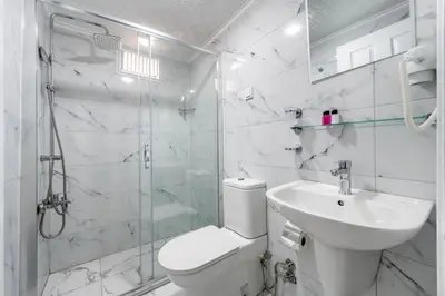 a bathroom with a toilet and a shower and a sink at Taksim Trust Hotel in Istanbul