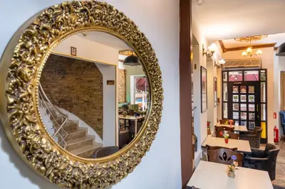 a large gold mirror on the wall of a restaurant at Taksim Trust Hotel in Istanbul