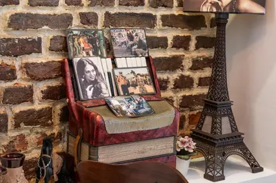 a table with a lamp and a table with pictures on it at Taksim Trust Hotel in Istanbul