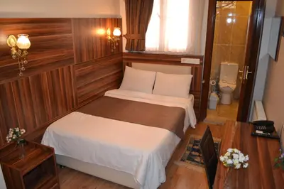 a bedroom with a bed and a toilet in it at New Fatih Hotel in Istanbul