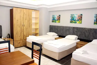 a room with beds and a table and chairs at Avist Hotel Avcılar in Avcılar