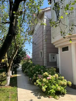 a garden of flowers next to a building at Villa Elysium in Gebze