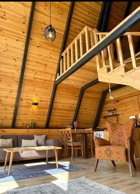 a room with a wooden ceiling with a staircase at Teona Kartepe Bungalov in Kartepe