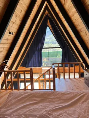 a bed in a room with a large window at Teona Kartepe Bungalov in Kartepe