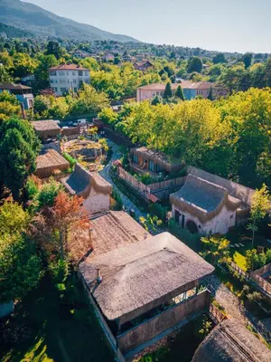 an aerial view of a village with trees and buildings at Feronia Suites in Masukiye