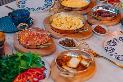 a table topped with bowls of food on plates at Feronia Suites in Masukiye