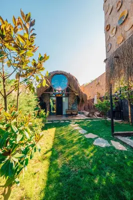 an external view of a building with a yard at Feronia Suites in Masukiye