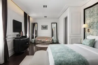 a bedroom with a bed and a living room at Sanasaryan Han, a Luxury Collection Hotel, Istanbul in Istanbul