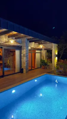 a swimming pool in front of a house at night at Mjoraste Sapanca Boutique Villas in Sapanca