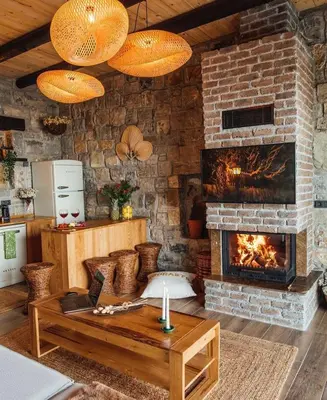 a living room with a brick wall and a fireplace at Mjoraste Sapanca Boutique Villas in Sapanca
