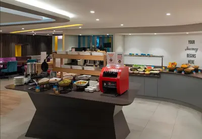 a food counter in a restaurant with a red appliance at Hampton By Hilton Istanbul Sirkeci in Istanbul