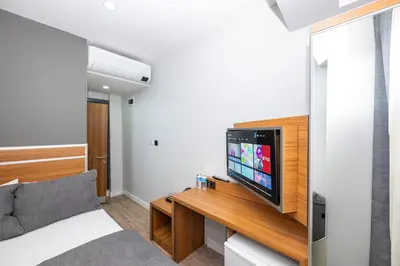 a living room with a tv and a couch at mayza otel in Istanbul