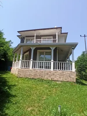 a house with a large porch on a lawn at Grandvadi Villa kapalı ısıtmalı havuz in Sapanca