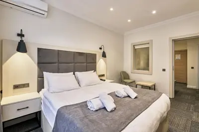 a bedroom with a large bed with two towels at Stamboul Hotel & Suites in Istanbul