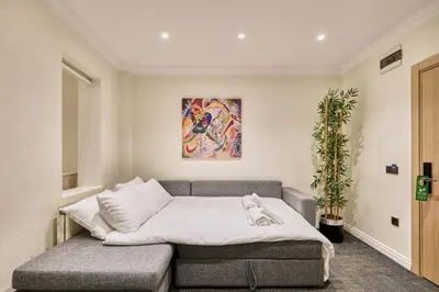 a living room with a couch and a painting on the wall at Stamboul Hotel & Suites in Istanbul