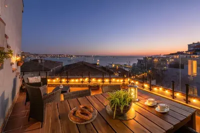 a table on a balcony with a view of the city at Bosphorus view-Airport shutle-High Speed WIFI-Private parking in Istanbul