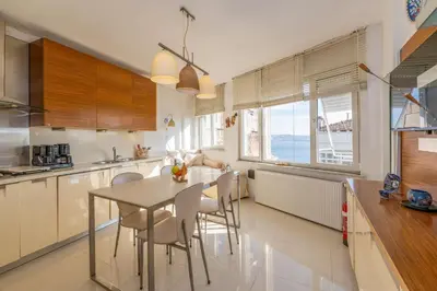 a kitchen with a table and chairs in a kitchen at Bosphorus view-Airport shutle-High Speed WIFI-Private parking in Istanbul