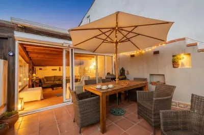 a patio with a wooden table with an umbrella at Bosphorus view-Airport shutle-High Speed WIFI-Private parking in Istanbul