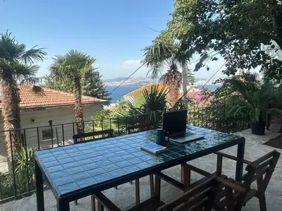 a blue table with a laptop on top of it at Büyükada Al Köşk in Buyukada