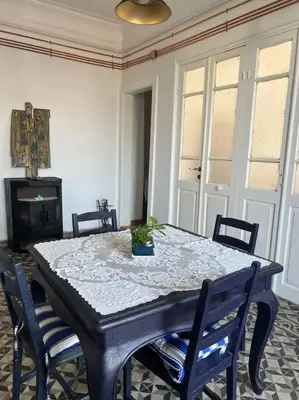 a dining room with a table with chairs and a plant on it at Büyükada Al Köşk in Buyukada