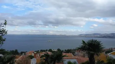a view of a large body of water with a ship at Büyükada Al Köşk in Buyukada