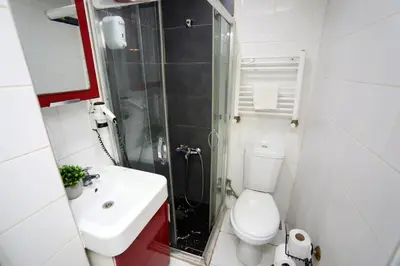 a bathroom with a toilet and a sink and a shower at Arkem Maltepe in Istanbul