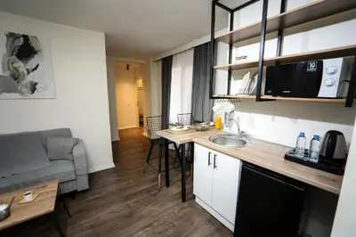 a small apartment kitchen with a sink and a couch at Arkem Maltepe in Istanbul
