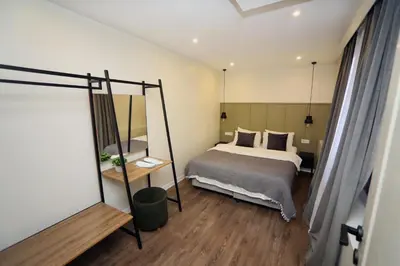 a bedroom with a bed and a mirror at Arkem Maltepe in Istanbul