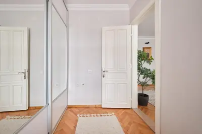 a hallway with two doors and a mirror at Charming Bagdat Avenue Hideaway, Near Marina in Istanbul