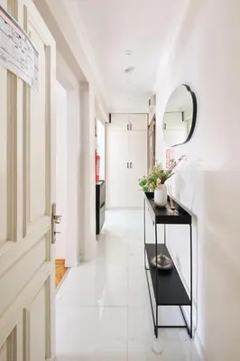 a hallway with a black table and a mirror at Charming Bagdat Avenue Hideaway, Near Marina in Istanbul