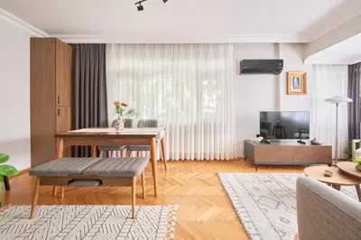 a living room with a table and a couch at Charming Bagdat Avenue Hideaway, Near Marina in Istanbul