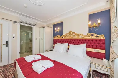 a bedroom with a large bed with two towels on it at Galatower Hotel in Istanbul