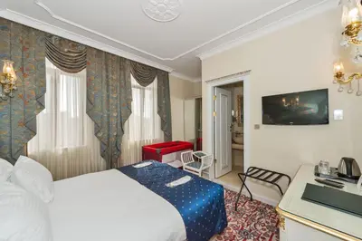 a hotel room with a bed and a desk at Galatower Hotel in Istanbul