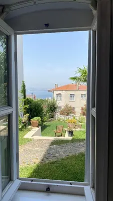an open window with a view of a yard at Mansion Miliá in Adalar
