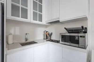 a kitchen with white cabinets and a microwave at Bright Private Modern 2BD1Bath Bebek Gem! #247 in Istanbul