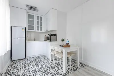 a white kitchen with a table and a refrigerator at Bright Private Modern 2BD1Bath Bebek Gem! #247 in Istanbul