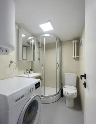 a bathroom with a washing machine and a toilet at Gorgeous Bright New 2BD Central Home! #212 in Istanbul