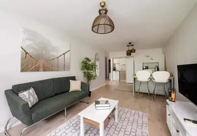a living room with a green couch and a table at Gorgeous Bright New 2BD Central Home! #212 in Istanbul