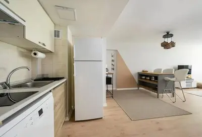a kitchen with a white refrigerator and a table at Gorgeous Bright New 2BD Central Home! #212 in Istanbul