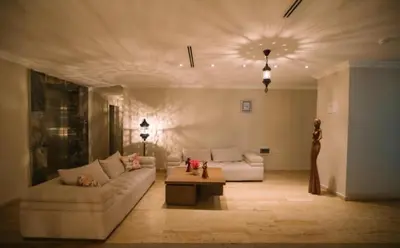 a living room with two couches and a table at Burgaz İzer Hotel in Lüleburgaz
