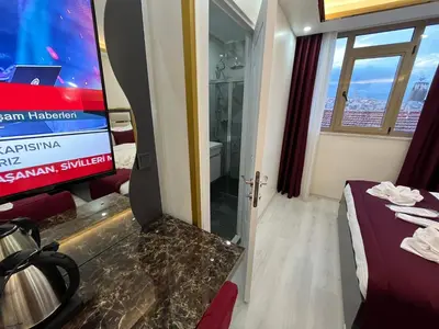 a room with a tv and a bed in a room at Lale Sultan Hotel in Istanbul